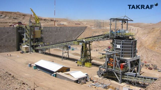 A Chilean mine where a TAKRAF Primary Crushing Station and Discharge Conveyor are located. The Conveyor transport the crushed material to a TAKRAF Transfer Silo equipped with a belt feeder.