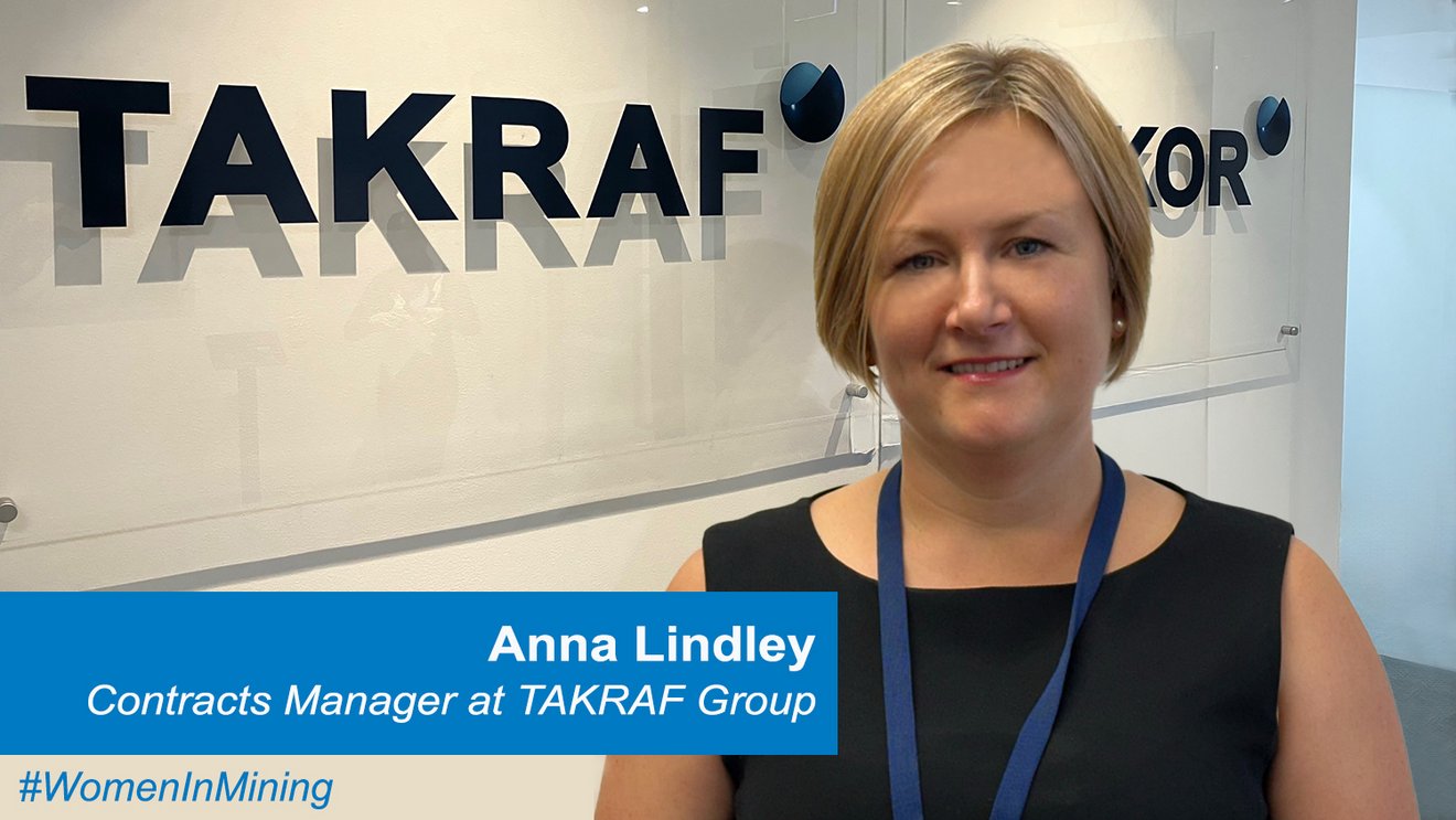 Anna Lindley standing in front of a TAKRAF logo