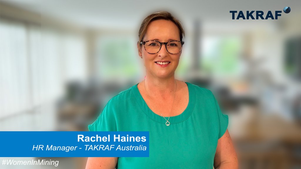 Rachel Haines, HR Manager for TAKRAF Group in Australia. TAKRAF HR Manager, Mrs Rachel Haines is standing in an office and smiles in the camera.