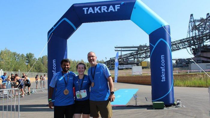 A TAKRAF Group relay team at the finish line of the F60 Triathlon.